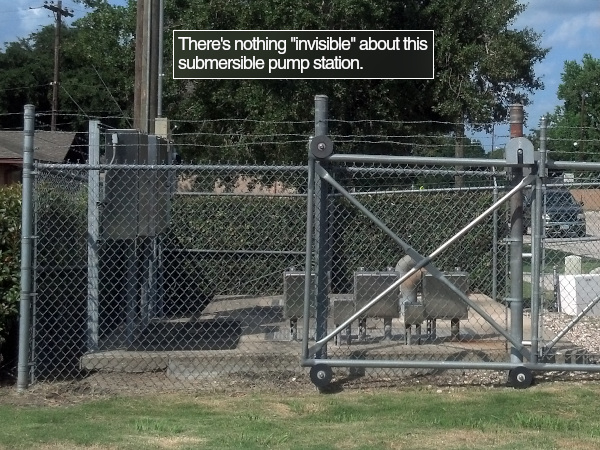 A submersible pumping station with fence, ventilation, barbed wire, control panels, and more visible above the ground